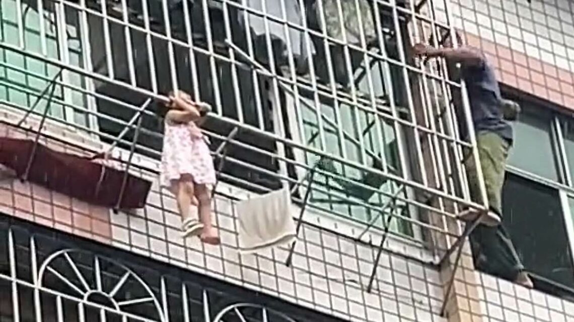 Hero neighbours rescue little girl dangling from fifth-floor window