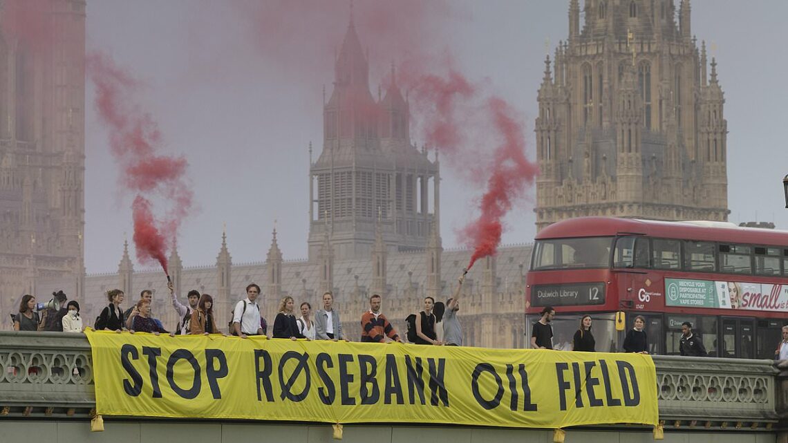 Protesters light flares on Westminster Bridge over Rosebank oil field