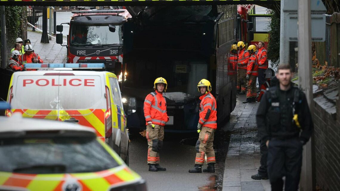 Roof of double-decker bus is torn off after hitting a low bridge